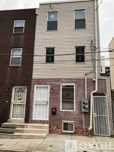 A building with a white door and a window with a black frame.