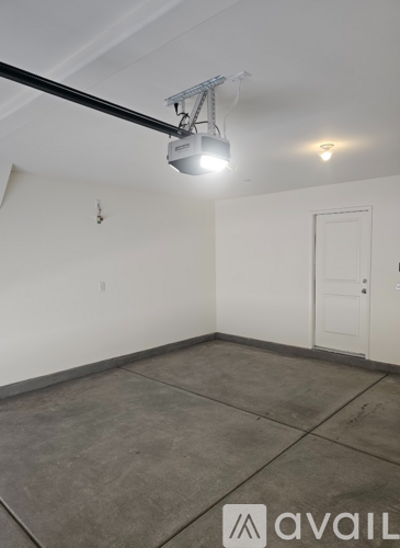 A room with a white door and a light on the ceiling.