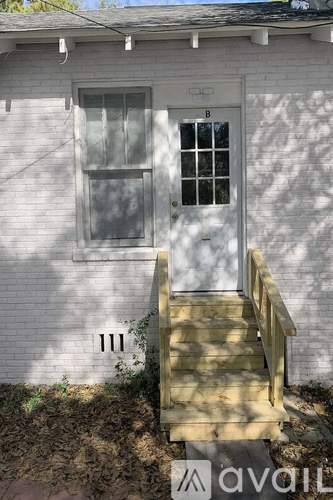 A white house with a window and a door.