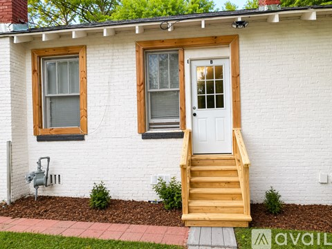 A white house with a window and a door.