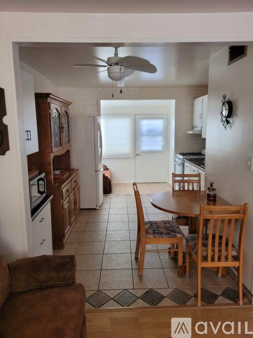 A kitchen with a table and chairs in the middle of the room.