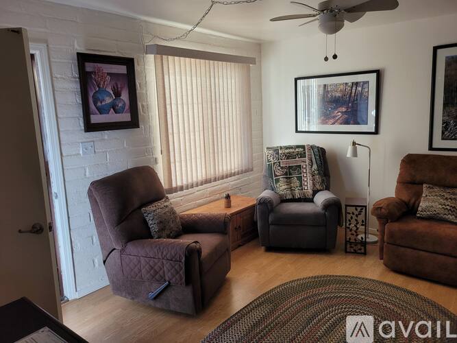 A living room with two chairs and a table.