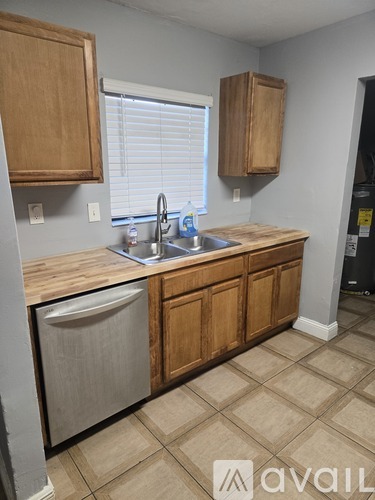 A kitchen with wooden cabinets and a sink.