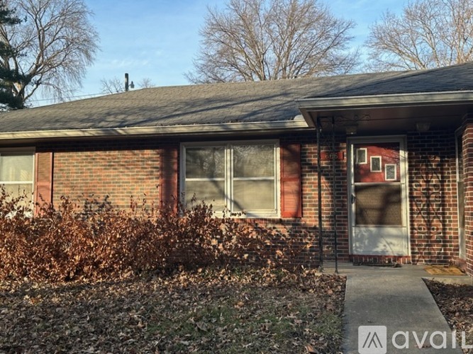 A house with a brick facade and a closed door.