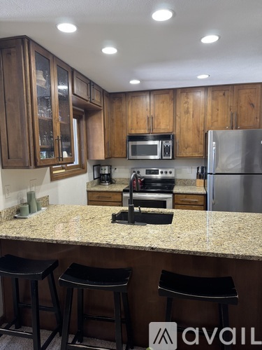 A kitchen with granite countertops and stainless steel appliances.