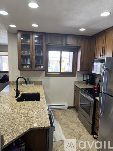 A kitchen with granite countertops and stainless steel appliances.