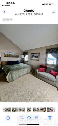 A bedroom with a bed and a couch.