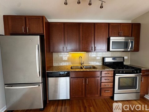 A kitchen with wooden cabinets and stainless steel appliances.