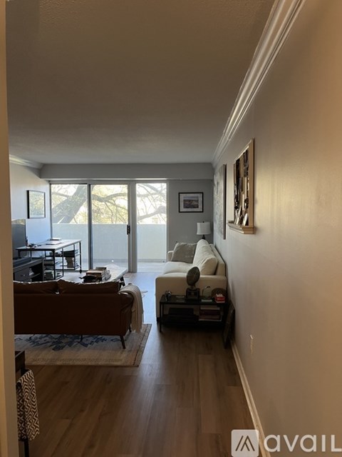 A living room with a brown couch and a white sofa.