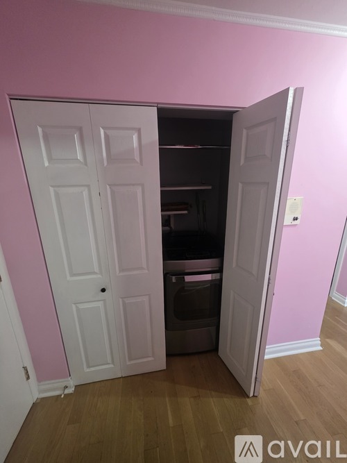 A white door is open to a small pantry.