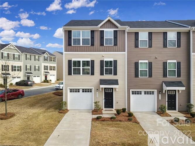 A two-story house with a garage is for sale.