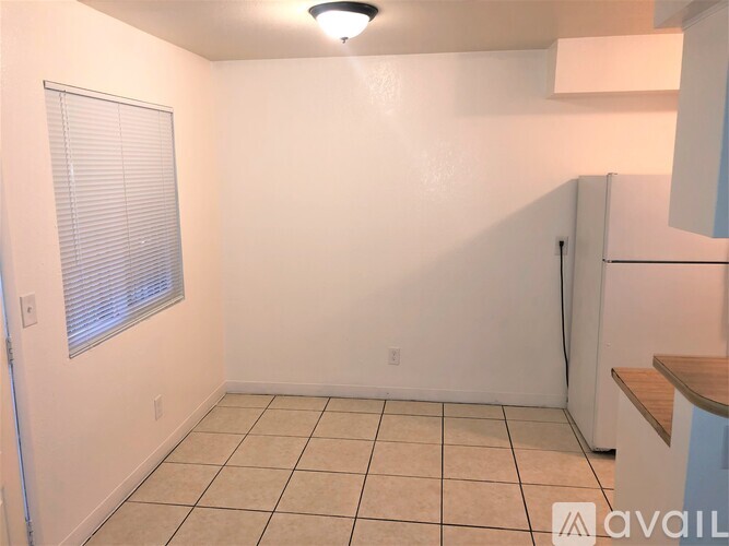 A small, empty room with a window and a door.
