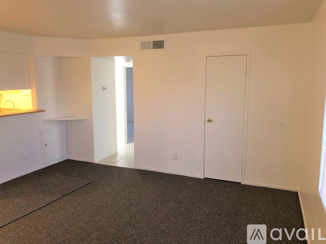 A room with white walls and a carpeted floor.