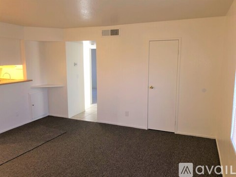 A room with white walls and a carpeted floor.
