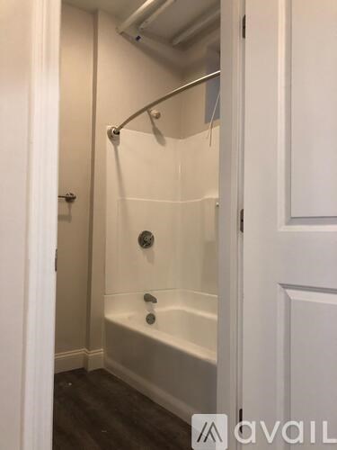 A white bathroom with a tub and a shower.