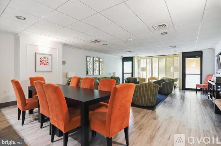 A dining room with a long table and chairs.