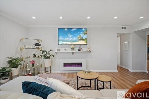 A bedroom with a large bed and a flat screen TV mounted on the wall.