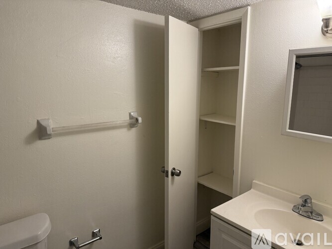 A small bathroom with a toilet, sink, and medicine cabinet.