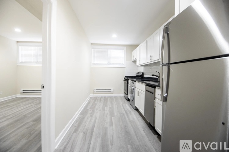 A kitchen with a refrigerator, dishwasher, and oven.