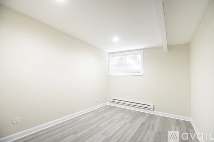 A room with a window and a radiator on the wall.