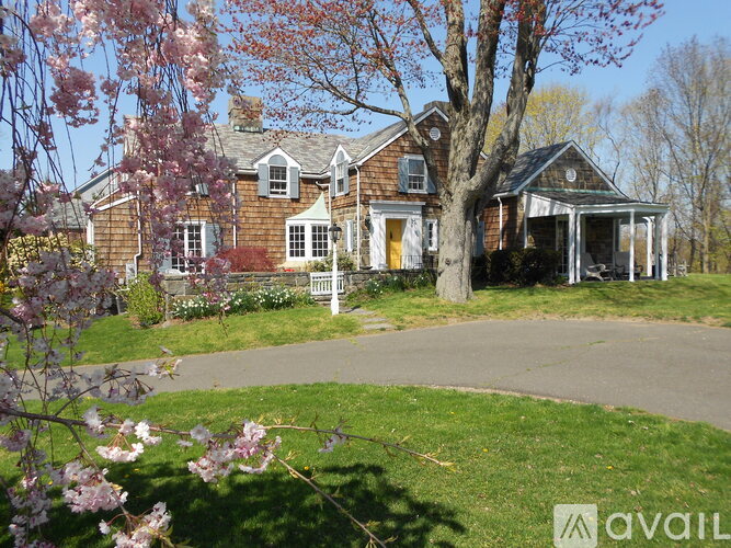 A house with a tree in front of it.