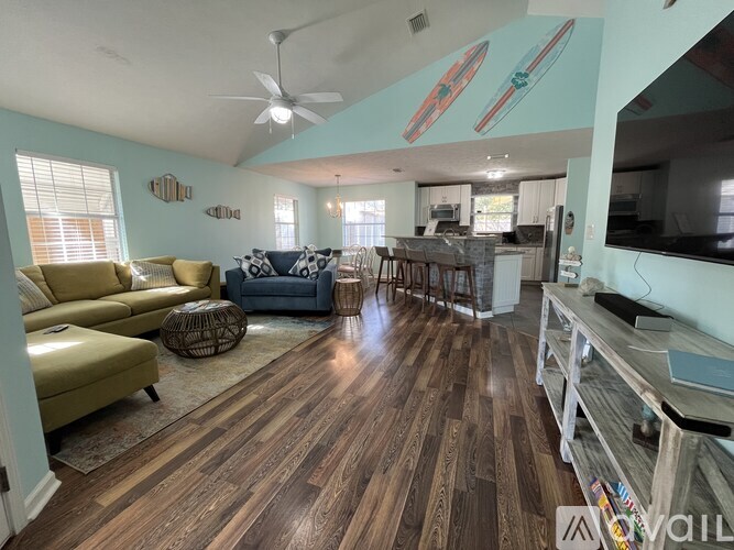 A living room with a blue couch and a yellow couch.