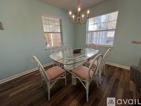 A dining room with a glass table and chairs.