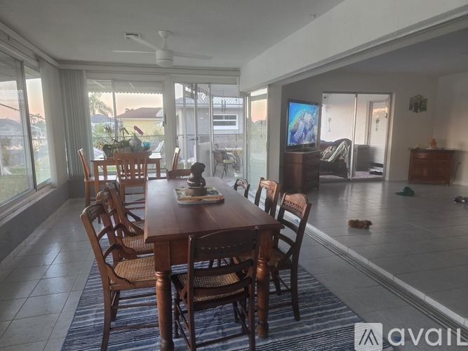 A dining room with a wooden table and chairs.