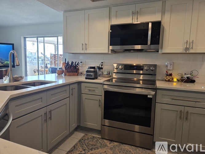 A kitchen with a stove top oven and microwave above it.