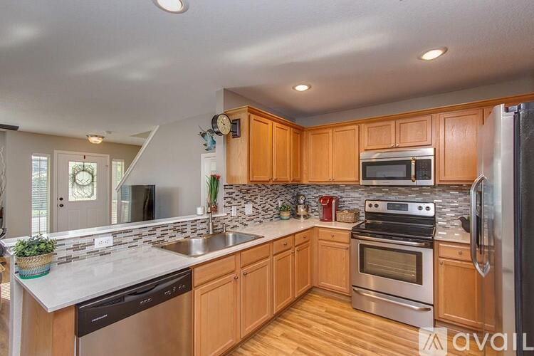 A kitchen with wooden cabinets and stainless steel appliances.