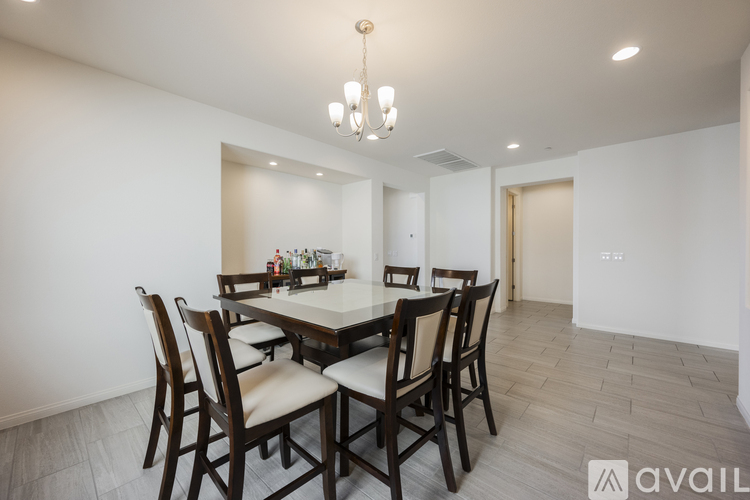 A dining room with a table set for six.