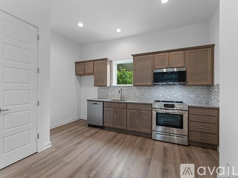 A kitchen with wooden cabinets and a stainless steel oven.