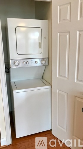 A white washing machine and dryer in a small space.