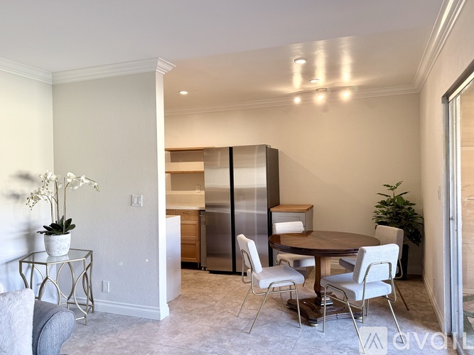 A dining room with a table set for four.