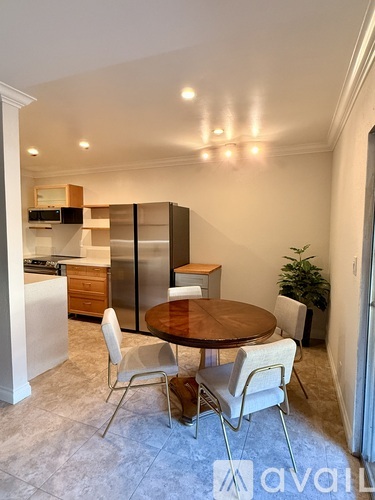 A kitchen with a table and chairs in the middle of the room.