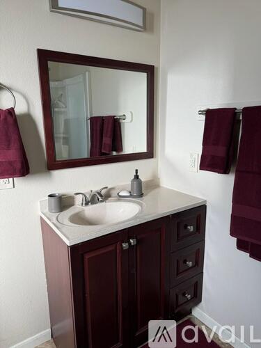 A bathroom with a sink and a mirror.