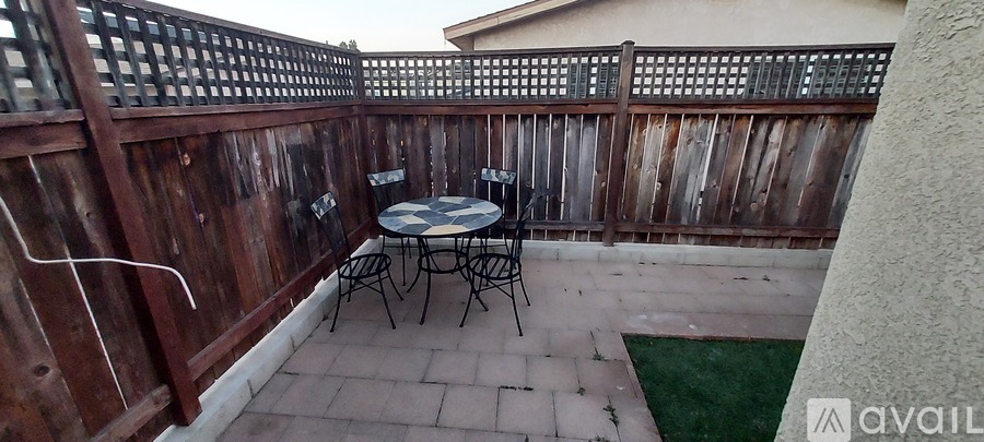 A patio with a table and chairs.