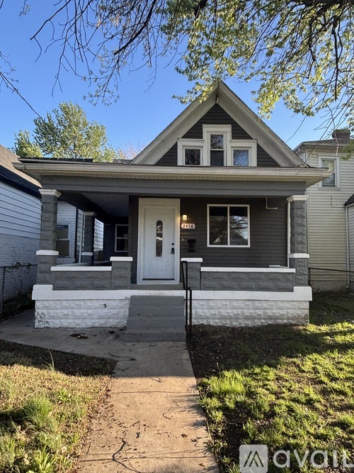 A house with a white door and windows is for sale.
