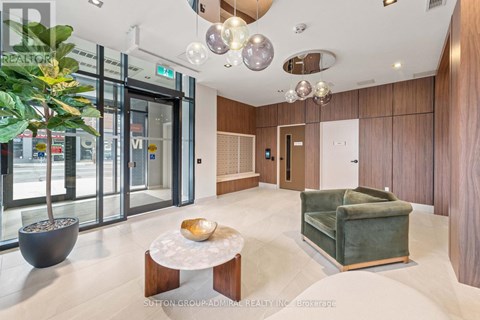 A modern living room with a green couch and a wooden coffee table.