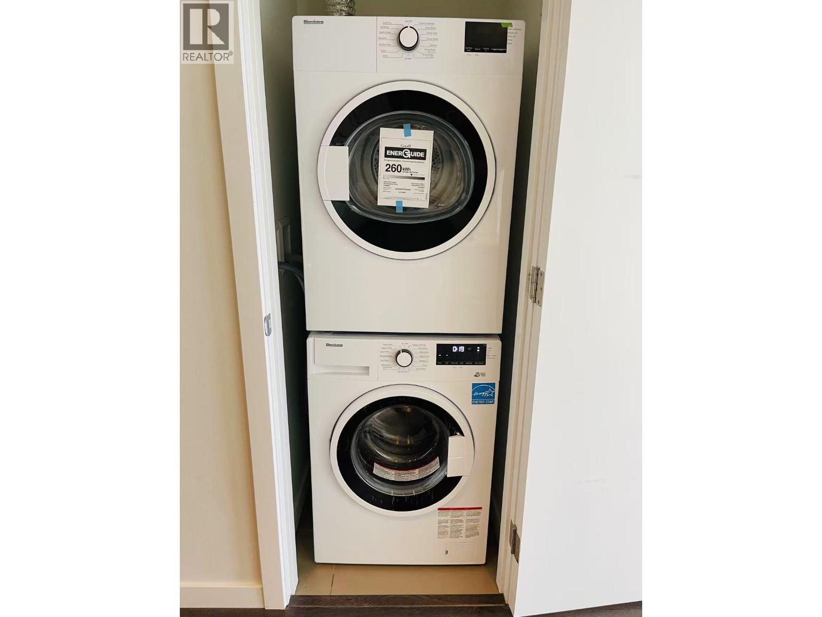 A white washing machine with the door open.