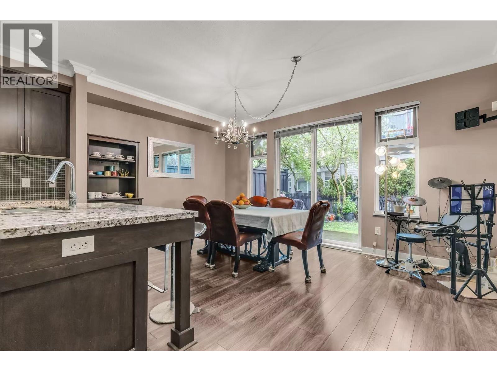 A kitchen with a dining table and chairs is shown.