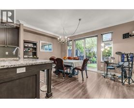 A kitchen with a dining table and chairs is shown.