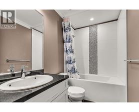 A bathroom with a sink, toilet, and bathtub.
