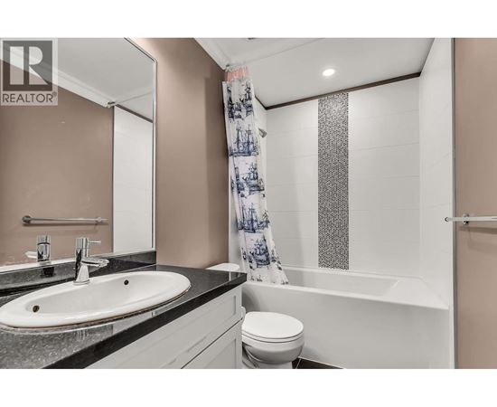 A bathroom with a sink, toilet, and bathtub.