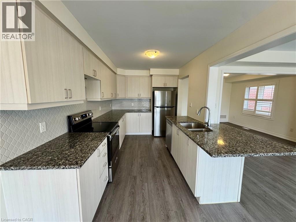 A kitchen with granite countertops and wooden floors.