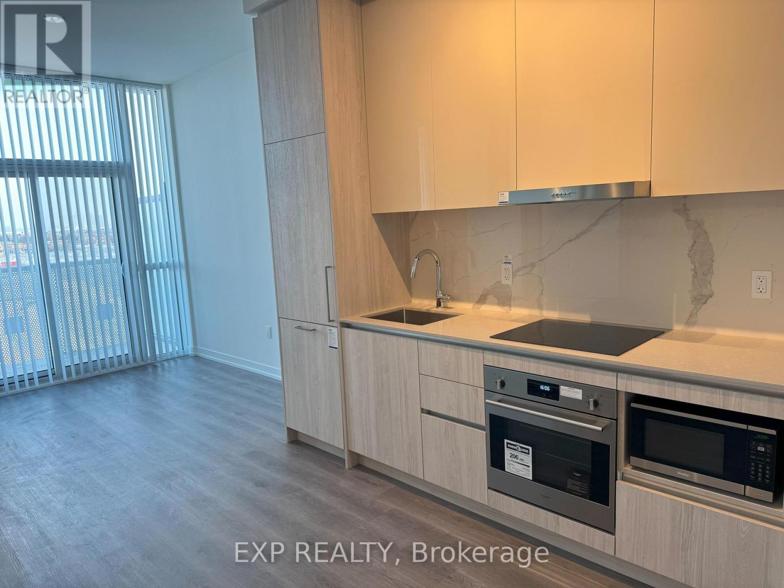 A kitchen with wooden cabinets and a stainless steel oven.