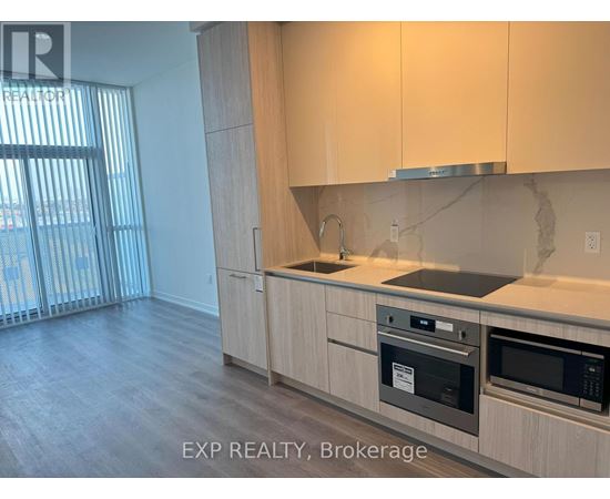 A kitchen with wooden cabinets and a stainless steel oven.