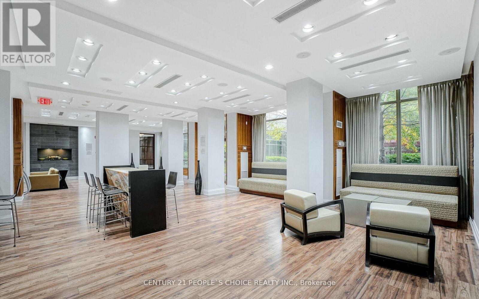 A spacious living room with a fireplace and comfortable seating.