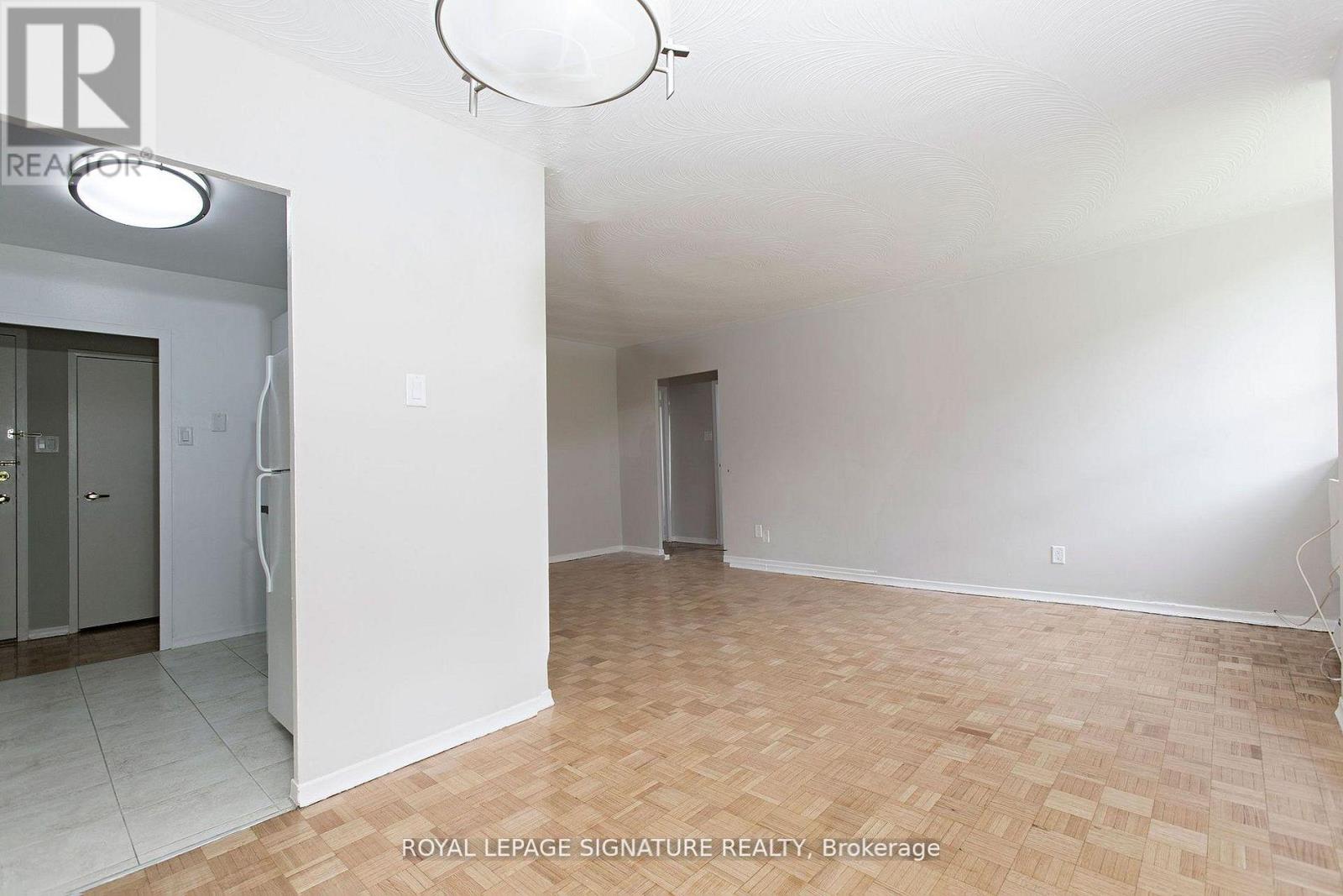 A white room with a doorway and a light fixture.