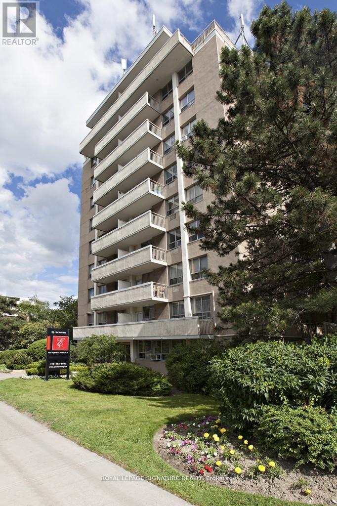 A tall building with balconies and a sign that says REALTOR.